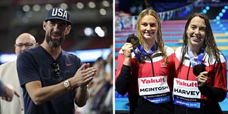 Michael Phelps reacts as Summer McIntosh wins the gold medal at the World Aquatics Championships while sharing podium with fellow Canadian swimmer