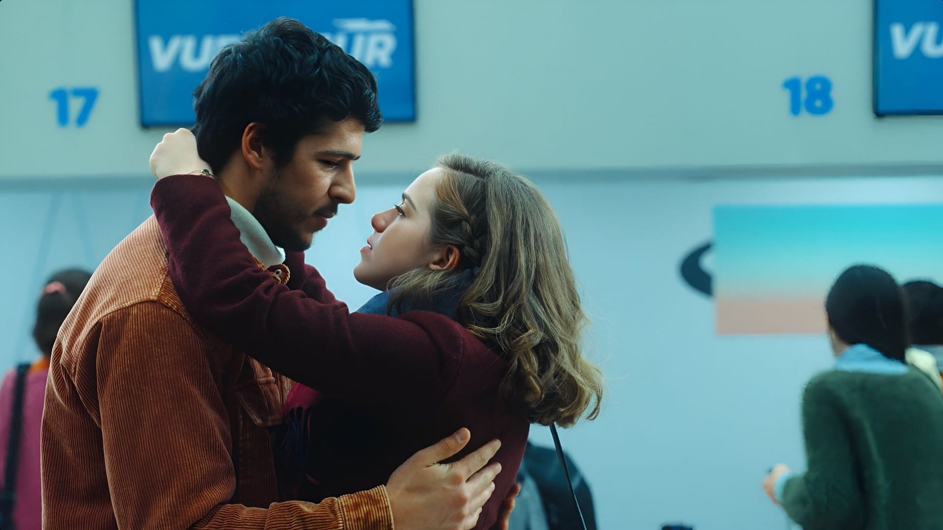 Mariana and Miguel embrace at the airport in a dramatic reconciliation scene from Almost Family.