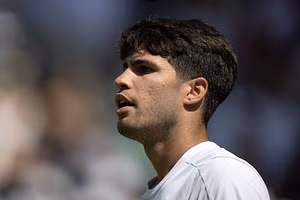 $40M-worth Carlos Alcaraz practices his golf swing with a tennis racket at the Wimbledon