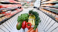 A shopping cart in a branch of the grocery retailer Kaufland contains salad and fruit (Image via Getty)