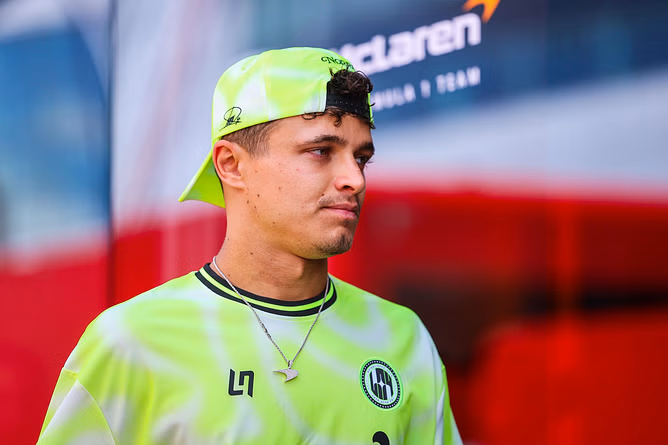 Watch: Lando Norris gets hit on the nose as he is on his way to greet fans