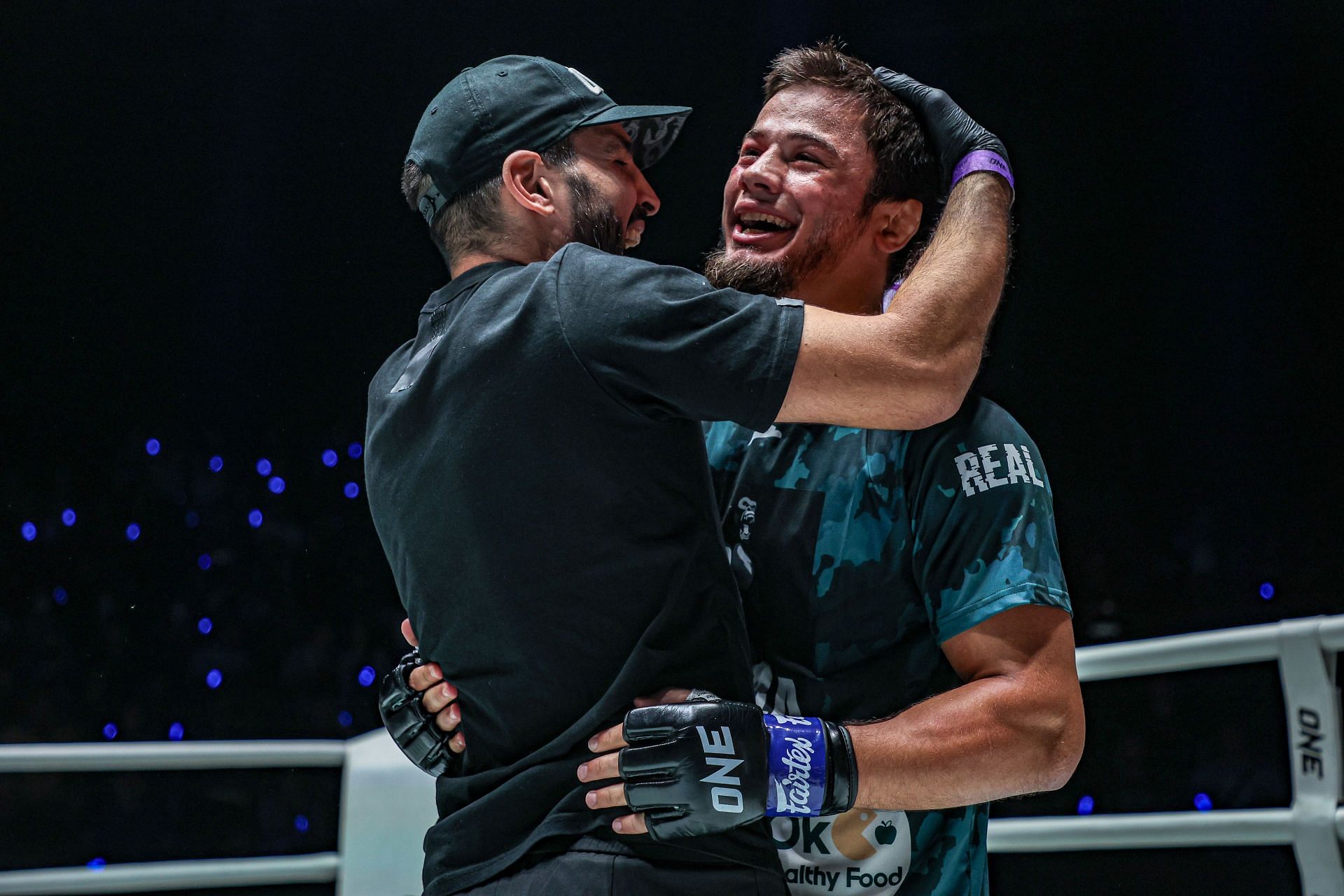 Abdulla Dayakaev (right) celebrates his win with Mehdi Zatout. [Image courtesy from ONE Championship]