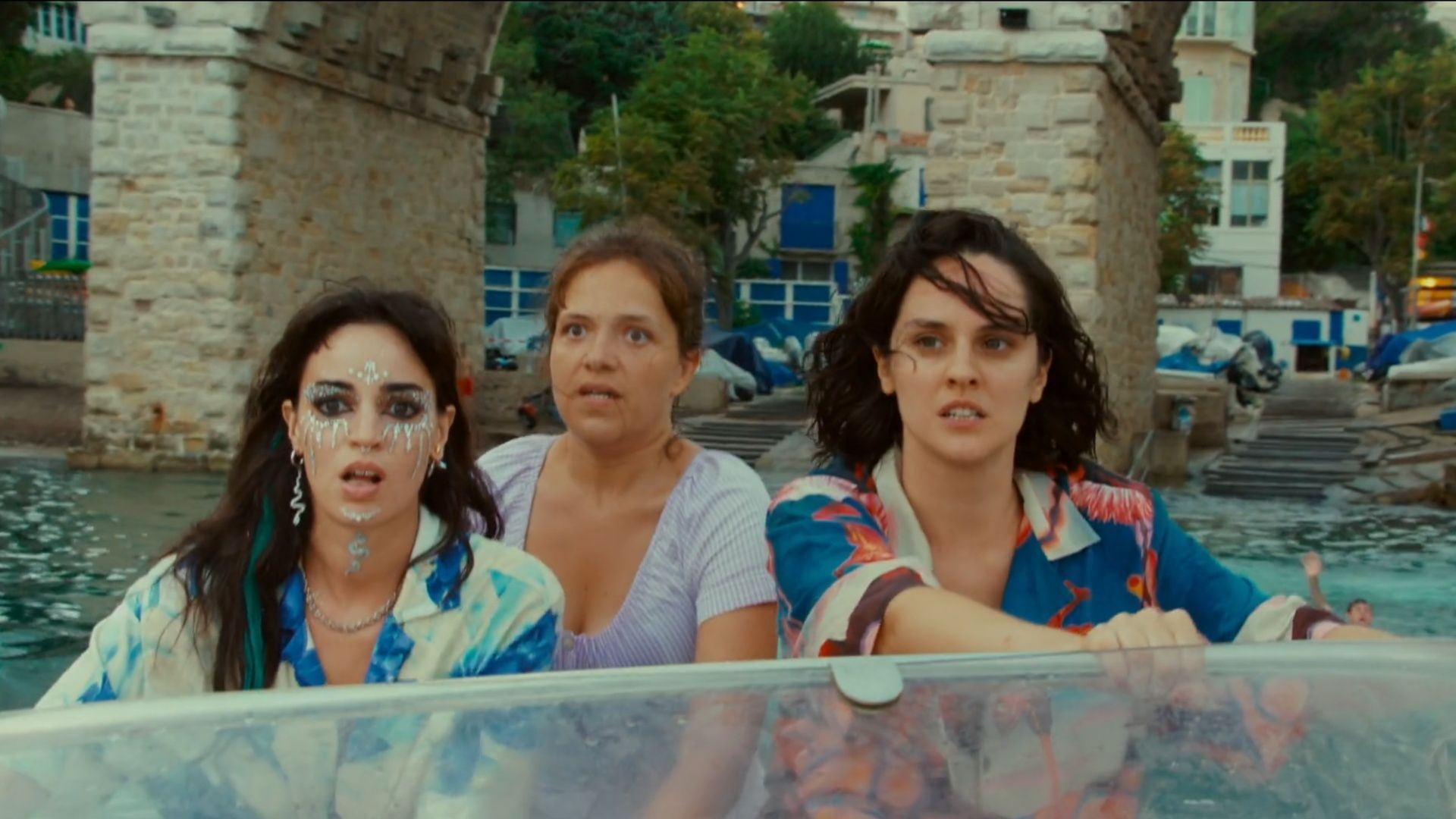 Ruby, Nicole, and Elise riding a speedboat with fearful determination in The Balconettes.