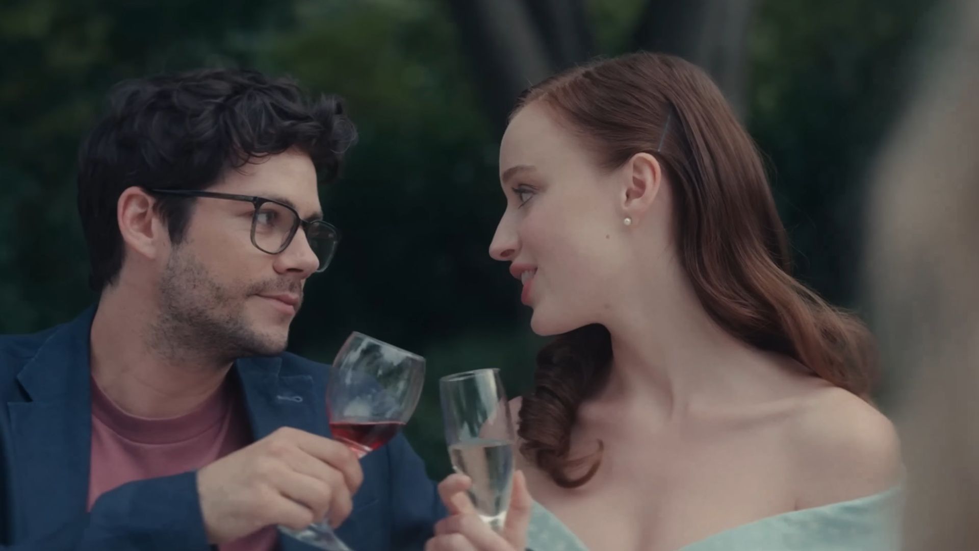 Dylan O&rsquo;Brien as Josh sits with Phoebe Dynevor as Liz during a family celebration in Anniversary (2025).