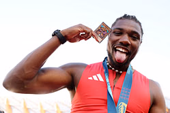 IN PICTURES: Noah Lyles rocks beige Summer Neutrals and Louis Vuitton Accent with sporting Iconic Blue-Eyes White Dragon Card