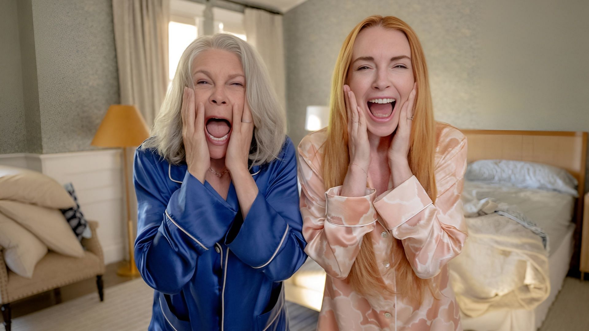 Jamie Lee Curtis and Lindsay Lohan in Freakier Friday, portraying Tess and Anna with Lily and Harper inside their bodies, screaming in surprise after the chaotic double swap.