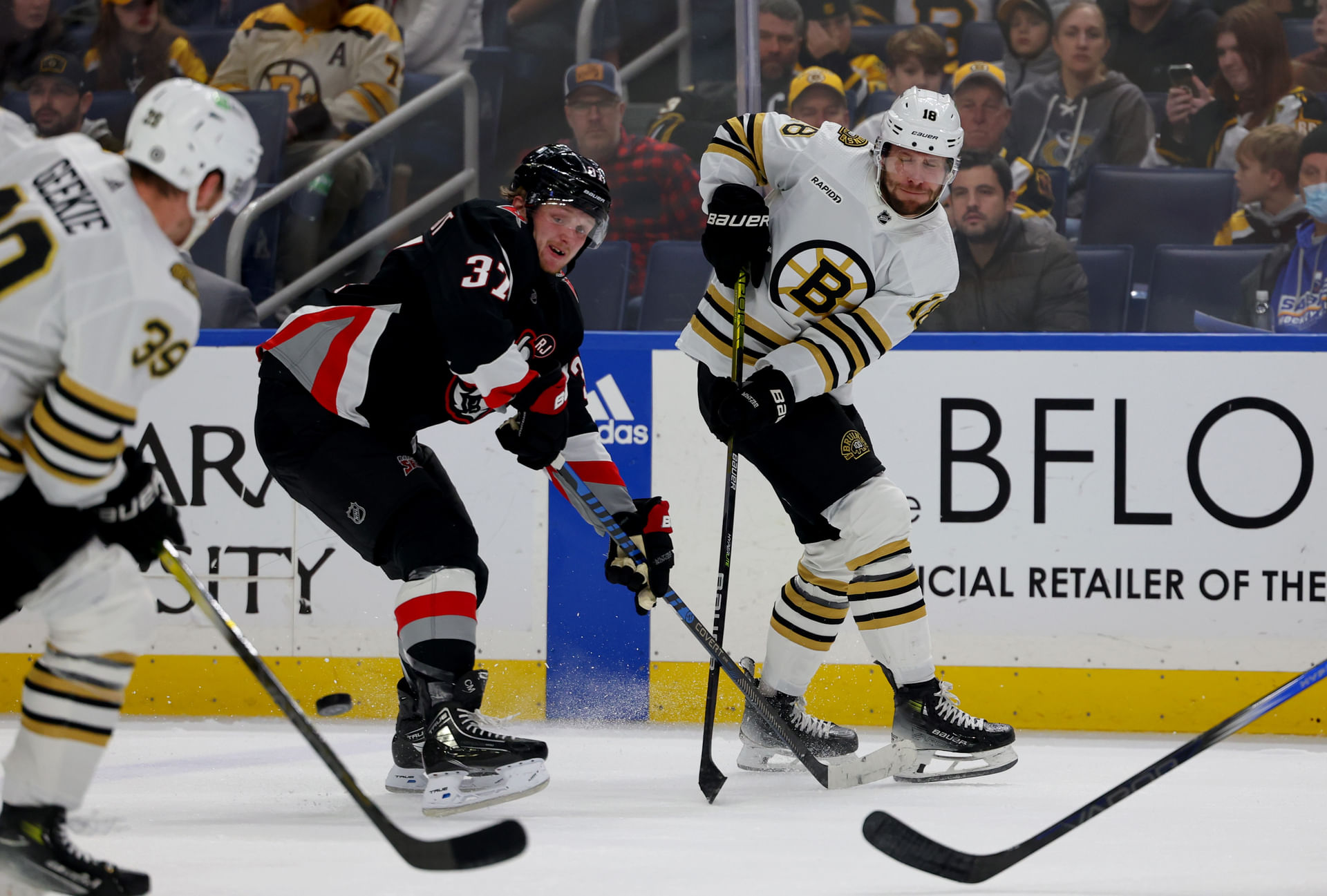 Dec 27, 2023; Buffalo, New York, USA; Buffalo Sabres center Casey Mittelstadt (37) tries to block a pass by Boston Bruins center Pavel Zacha (18) during the first period at KeyBank Center. Mandatory Credit: Timothy T. Ludwig-Imagn Images - Source: Imagn