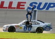 Carl Edwards does his signature back flip after winning the 2011 NASCAR Nationwide Series race at Nashville Superspeedway - Source: Imagn