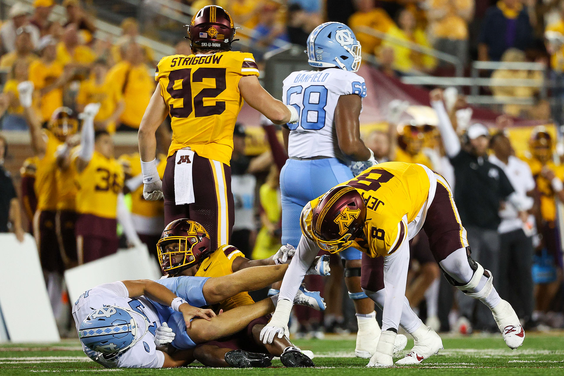 Aug 29, 2024; Minneapolis, Minnesota, USA; North Carolina Tar Heels quarterback Max Johnson (14) grabs his knee after being tackled during the second half against the Minnesota Golden Gophers at Huntington Bank Stadium. Mandatory Credit: Matt Krohn-Imagn Images