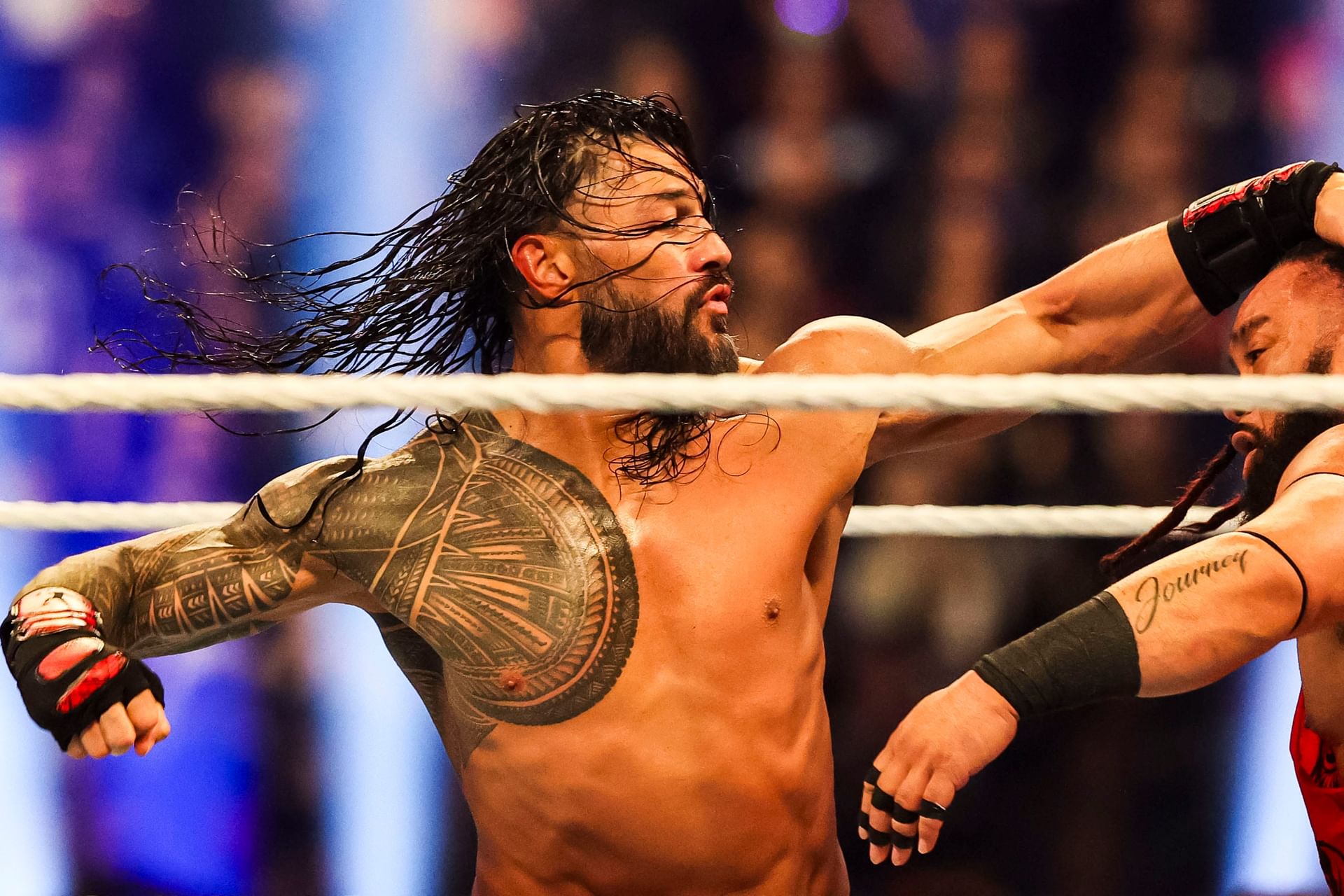 Roman Reigns throws a punch at Jacob Fatu (right) on Saturday, Feb. 1, 2025, during the WWE Royal Rumble at Lucas Oil Stadium in Indianapolis. - Source: Imagn