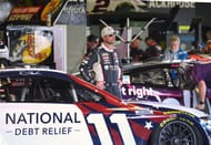 Denny Hamlin stands next to his no. 11 Toyota Camry XSE - Source: Imagn