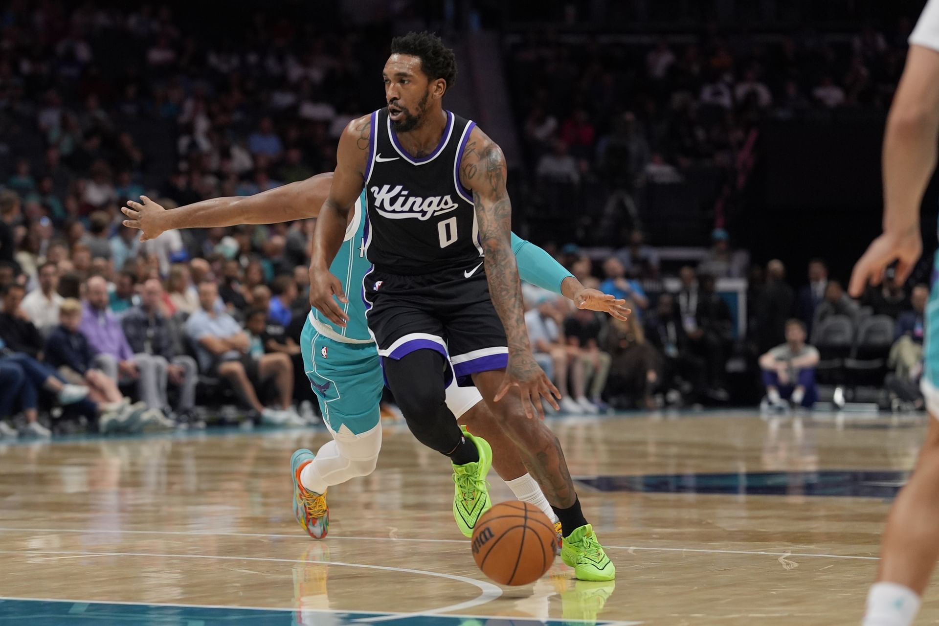 Kings guard Malik Monk (0) drives to the basket against the Charlotte Hornets during the second quarter at Spectrum Center. Mandatory Credit: Jim Dedmon-Imagn Images