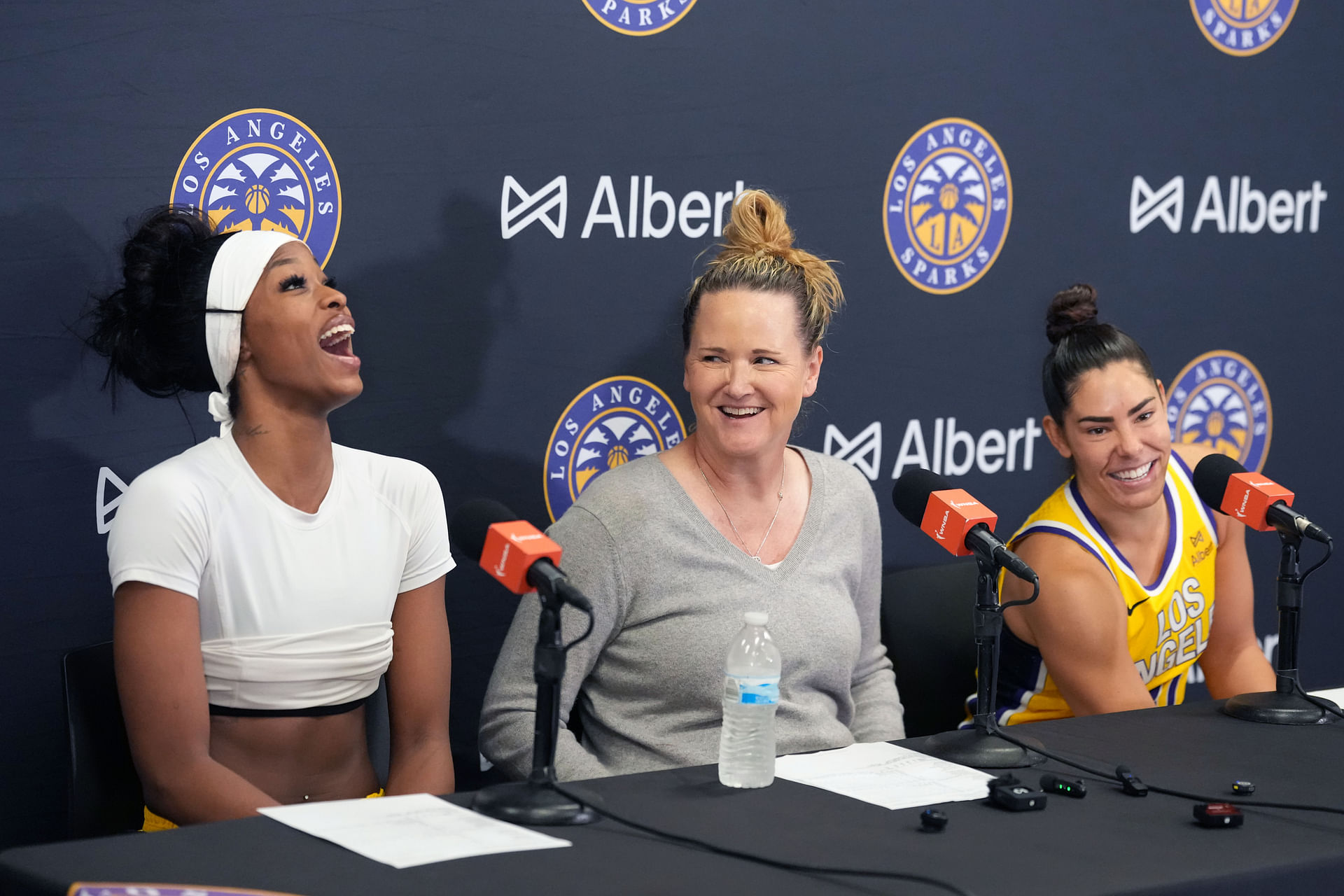 Aug 5, 2025; Los Angeles, California, USA; LA Sparks forward Rickea Jackson (left), coach Lynne Roberts (center) and guard Kelsey Plum react at press conference after the game against the Indiana Fever at the Crypto.com Arena. Mandatory Credit: Kirby Lee-Imagn Images - Source: Imagn