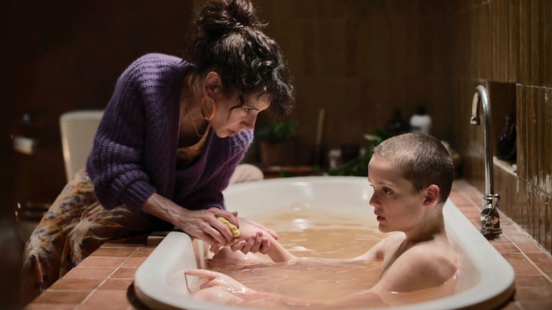 Laura bathes Ollie in Bring Her Back, a scene layered with disturbing intimacy and control. (Image via A24)