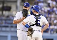 Clayton Kershaw meets with catcher Will Smith on the mound during a game - Source: Getty