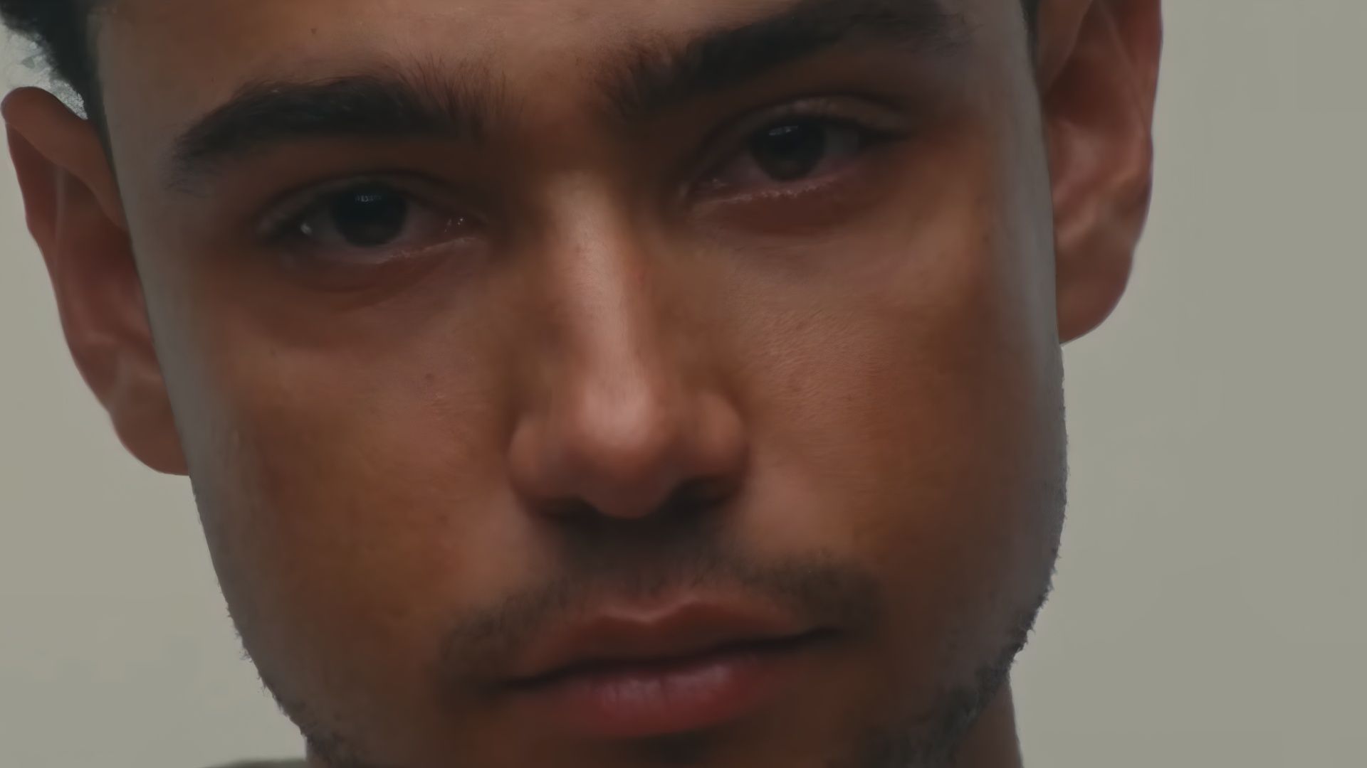 Close-up shot of a man&rsquo;s face from Lurker, reflecting the film&rsquo;s exploration of fame and power.