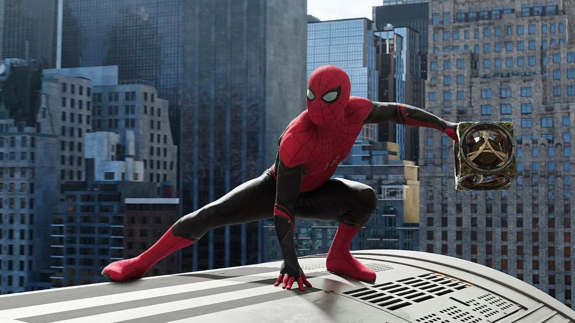 Spider-Man crouched on top of a train with a magical cube in hand, set against the backdrop of New York skyscrapers &mdash; from a previous Marvel Cinematic Universe film, not Spider-Man: Brand New Day.