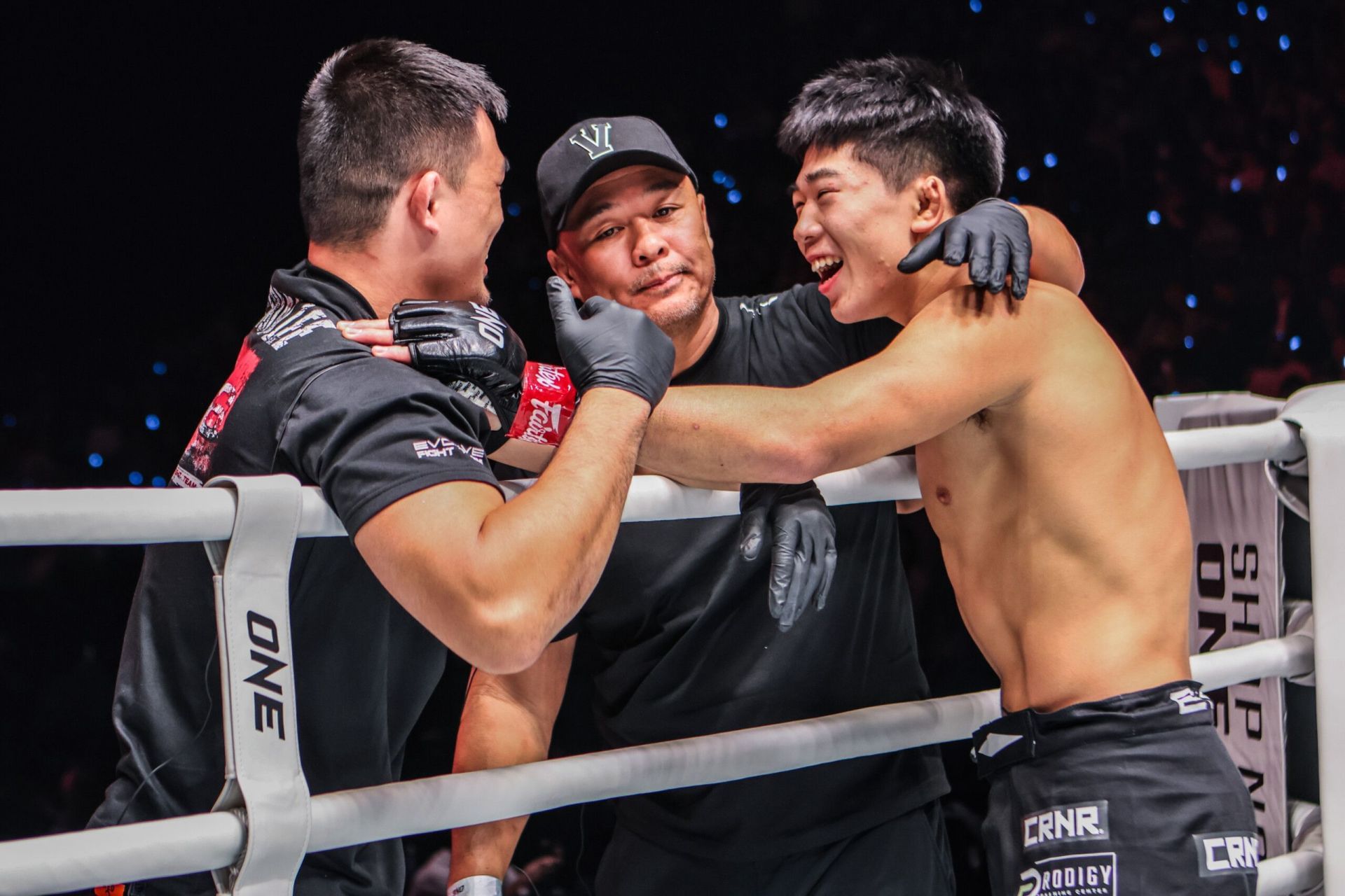 Adrian Lee (right) celebrates his most recent victory alongside his father Ken (centre) and elder brother Christian. [Image: ONE Championship]