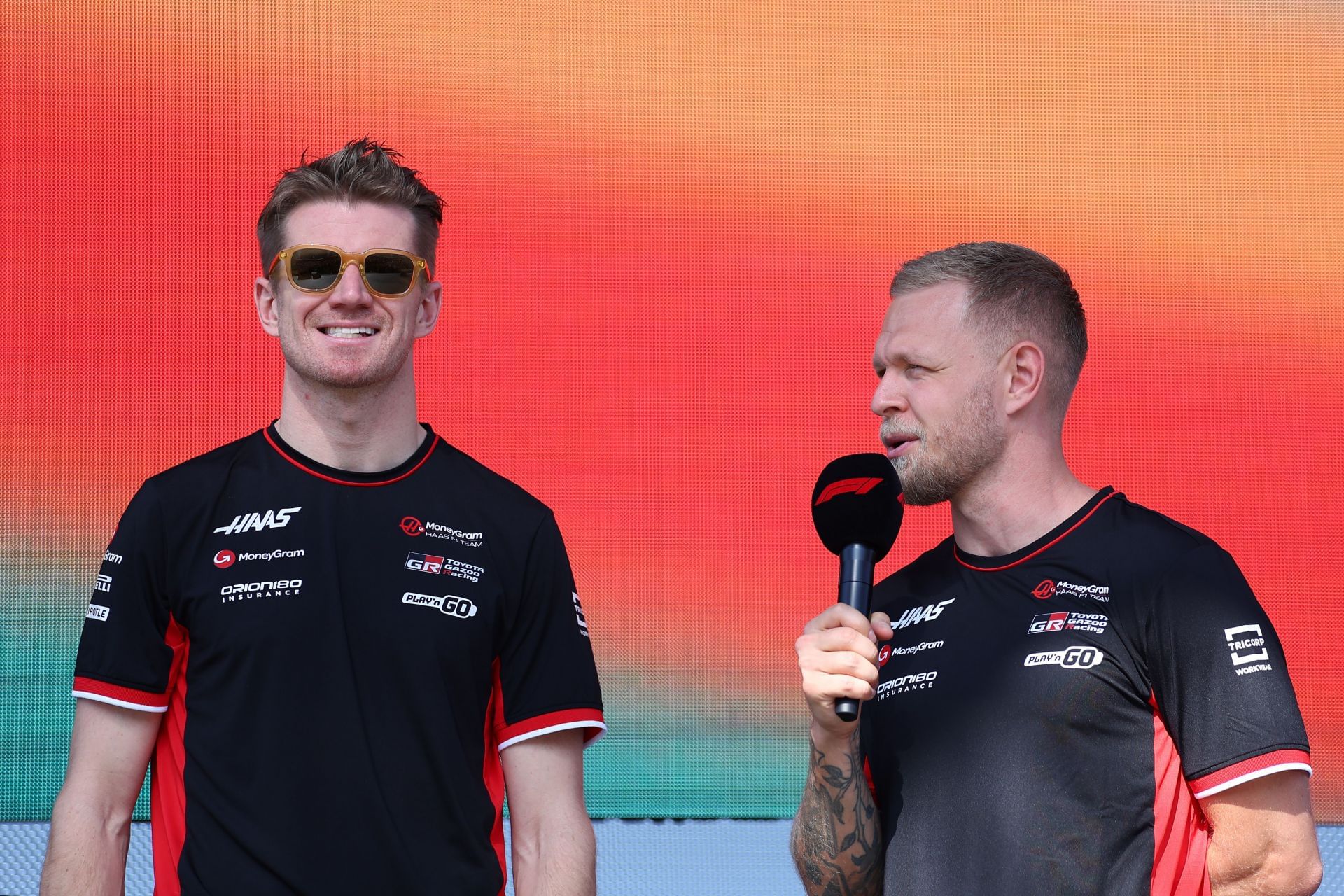 Nico Hulkenberg of Germany and Haas F1 and Kevin Magnussen of Denmark and Haas F1 talk to the crowd on the fan stage prior to final practice ahead of the F1 Grand Prix of Abu Dhabi - Source: Gett