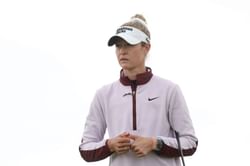 Nelly Korda poses in white on the beach as she runs through "200 seagulls"