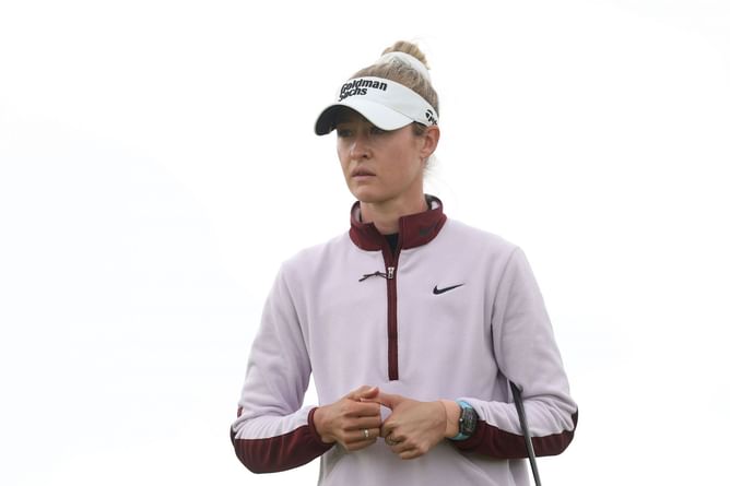 Nelly Korda poses in white on the beach as she runs through "200 seagulls"