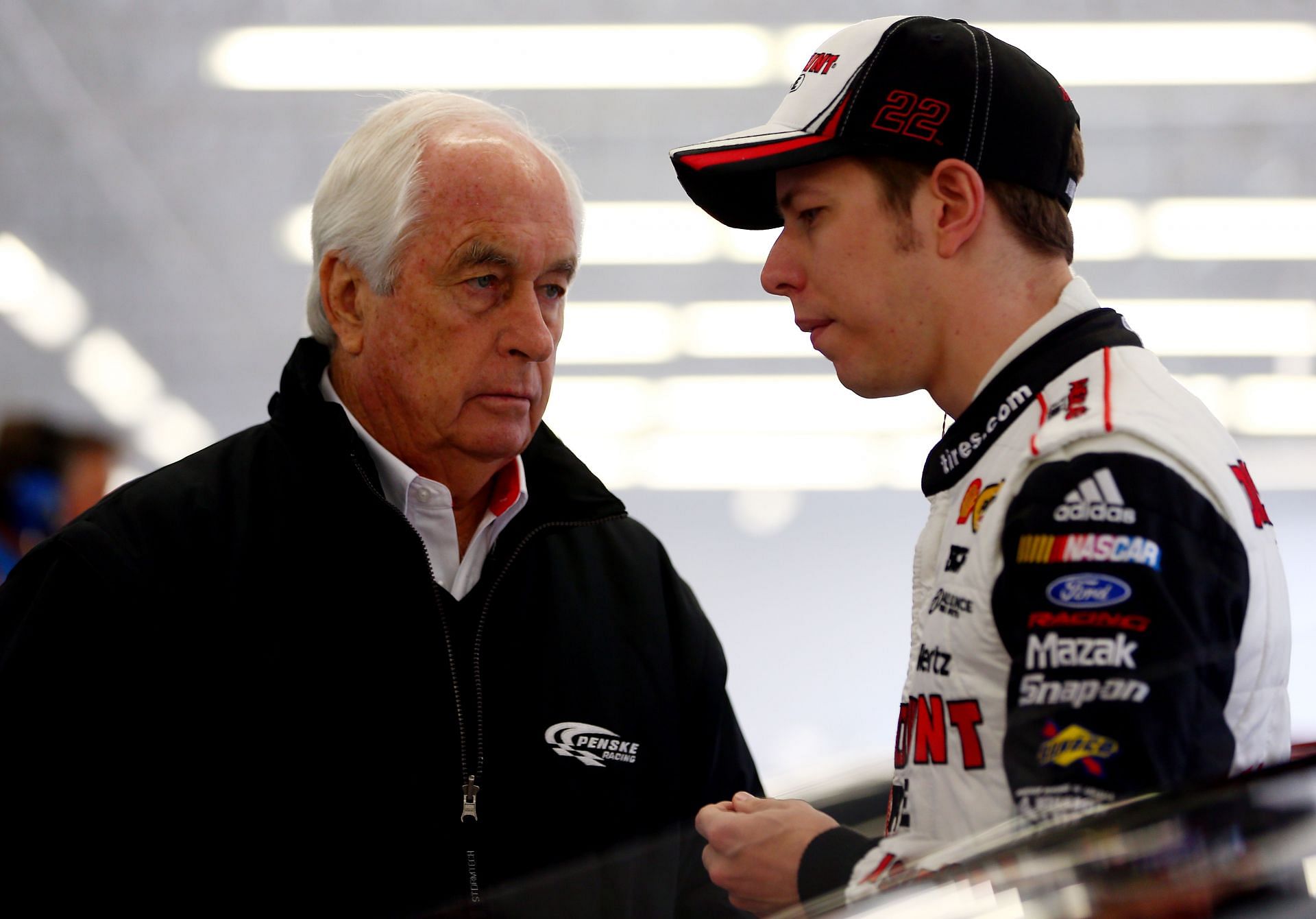 Brad Keselowski speaks with team owner Roger Penske during the 2013 Las Vegas Cup race. Source: Getty