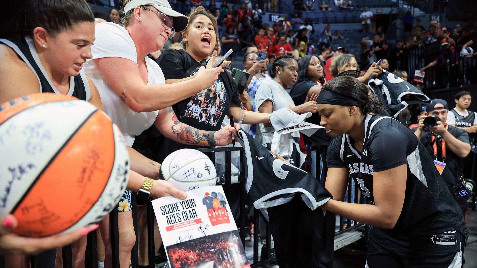 NaLyssa Smith #3 of the Las Vegas Aces signs autographs for fans after the Aces