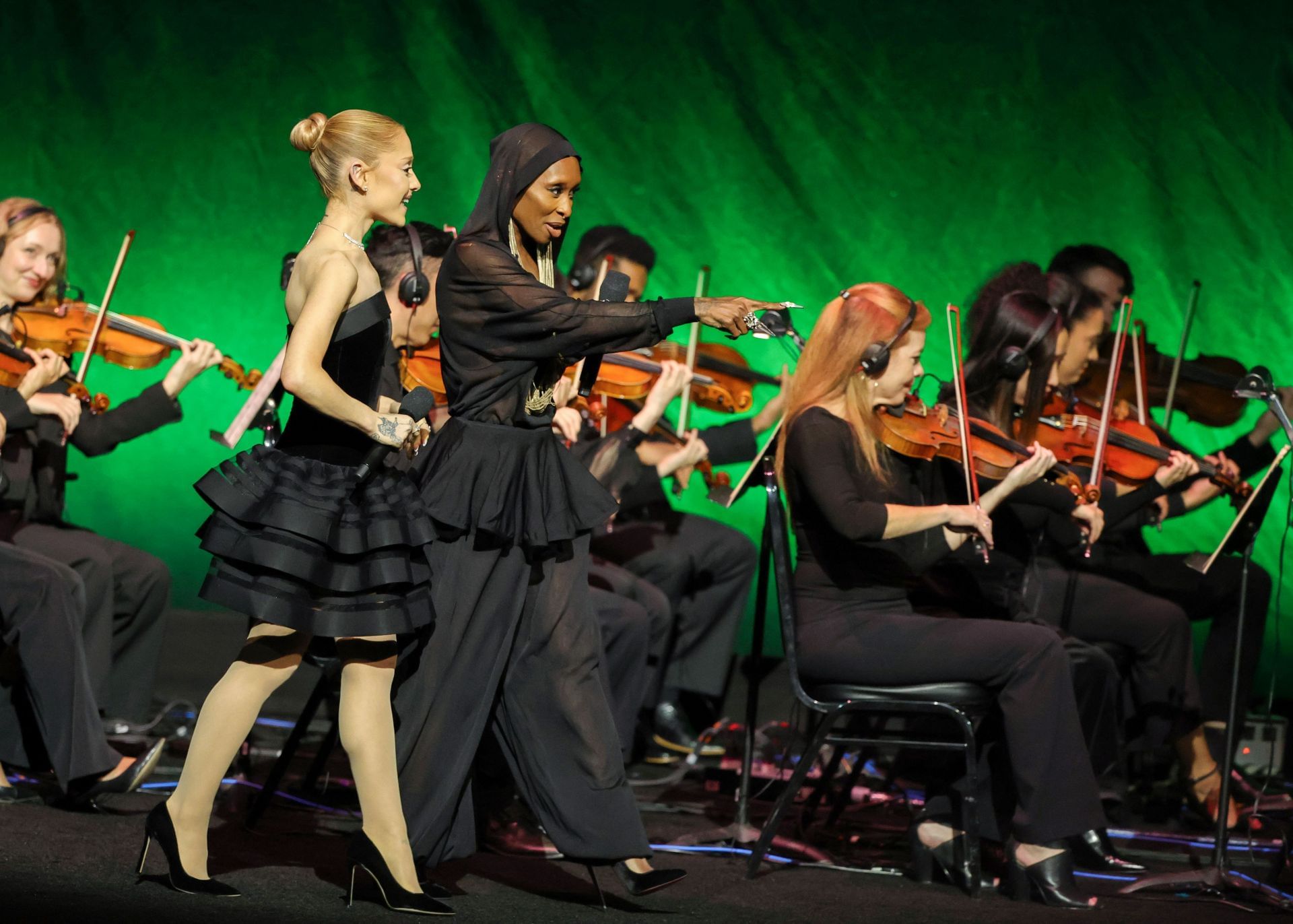 Ariana Grande and Cynthia Erivo walk onstage to promote the upcoming film &quot;Wicked: For Good&quot; at CinemaCon, the official convention of Cinema United, on April 02, 2025 (Image via Getty)
