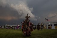 Native American dancers participate in a summer pow wow on June 8, 2018, on the Pine Ridge Reservation, South Dakota (Image via Getty)
