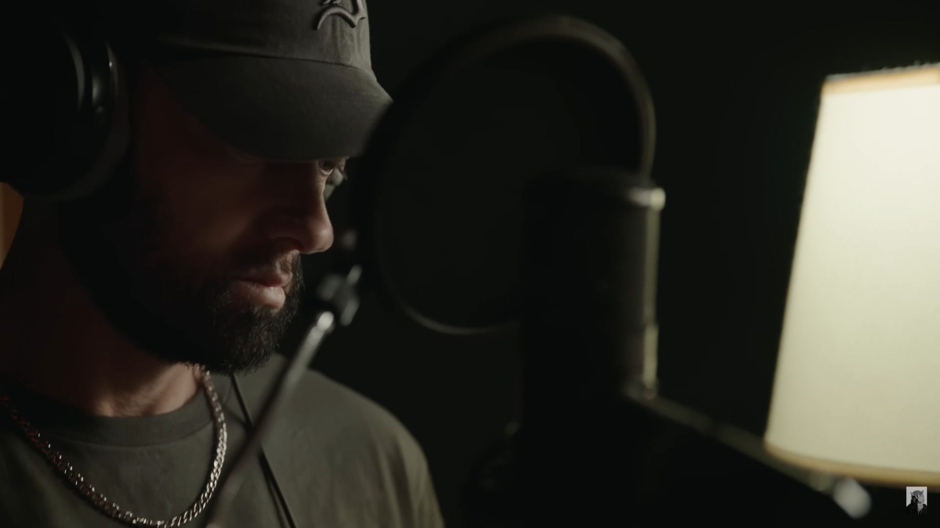 Eminem recording a voiceover for Stans (2025) in a studio booth. (Image via Eminem Music)