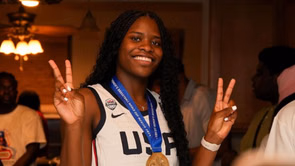 Ivanna Wilson-Manyacka proudly poses with Stephen Curry after winning MVP at Curry Camp