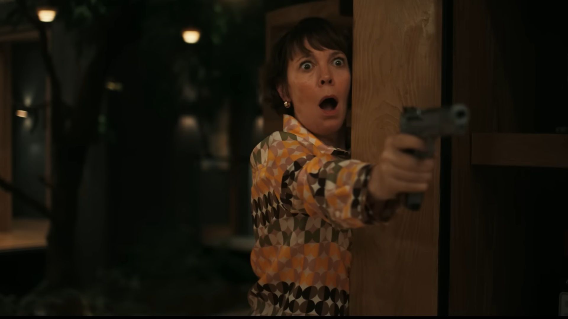 The Roses ending escalates as Ivy points a gun at Theo, symbolising how love and resentment collide in their marriage. (Image via YouTube/Searchlight Pictures)