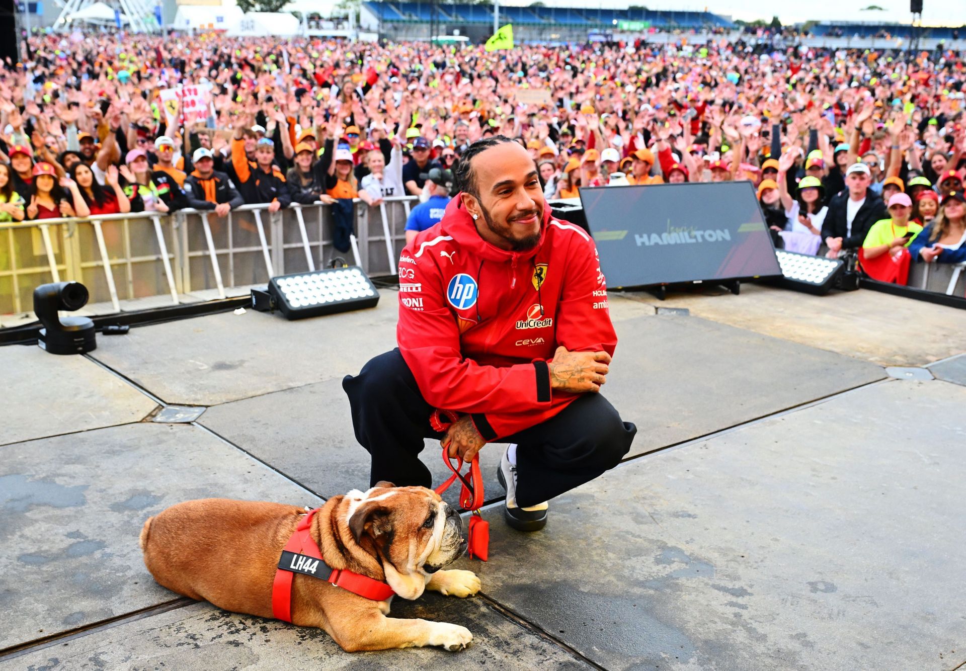 Lewis Hamilton of Great Britain and Scuderia Ferrari poses with Roscoe - Source: Getty Images