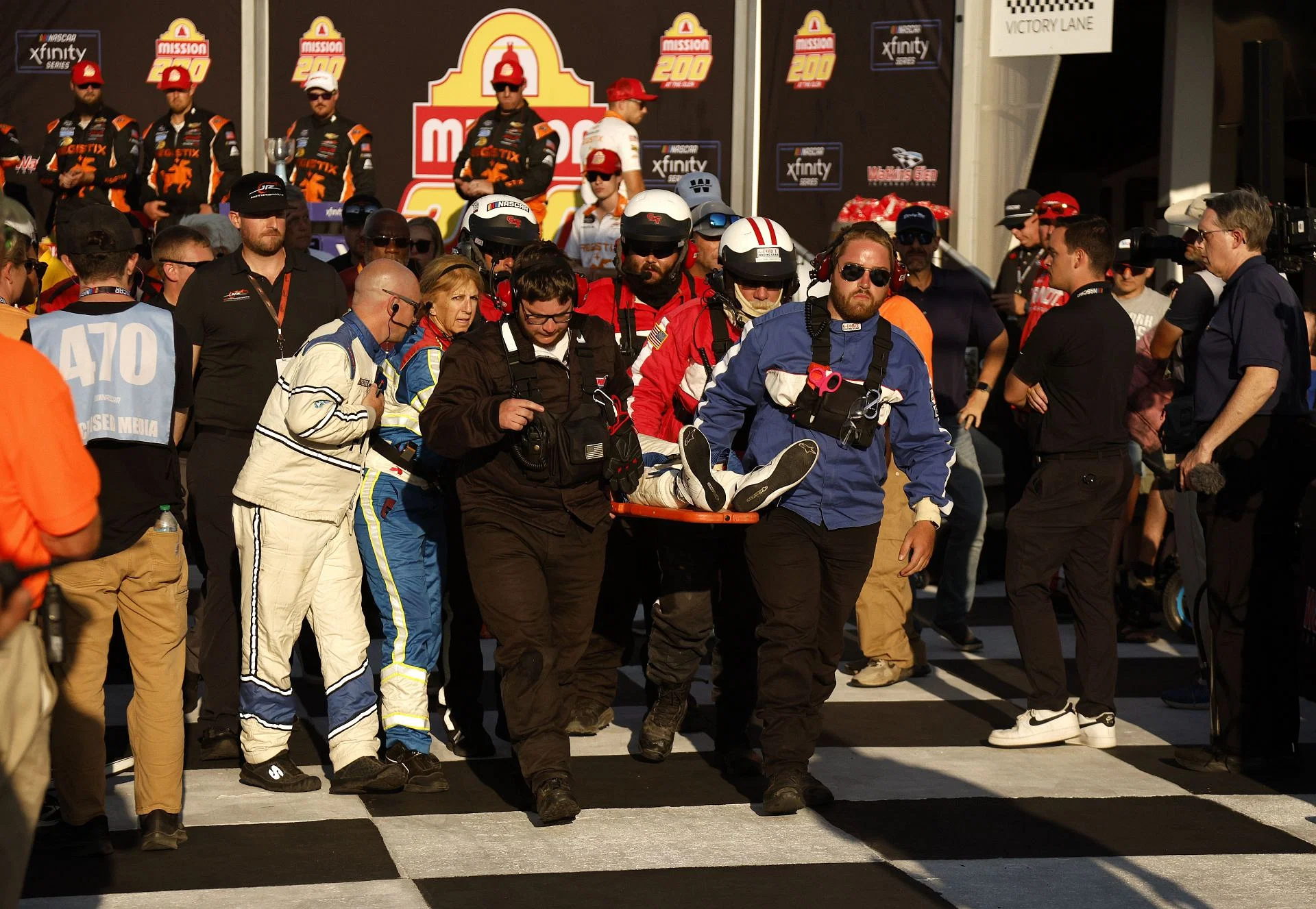 Connor Zilisch, driver of the #88 Registix Chevrolet, is taken out on a stretcher after a fall in victory lane following his NASCAR Xfinity Series Mission 200 win- Source: Getty