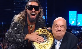 Paul Heyman reacts as Seth Rollins becomes the new WWE World Heavyweight Champion