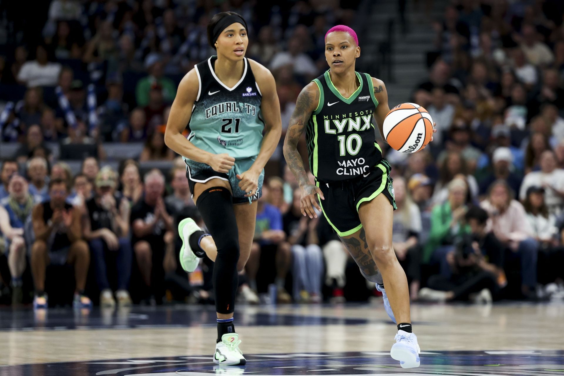 Courtney Williams #10 of the Minnesota Lynx dribbles up the court against Isabelle Harrison #21 of the New York Liberty - Source: Getty