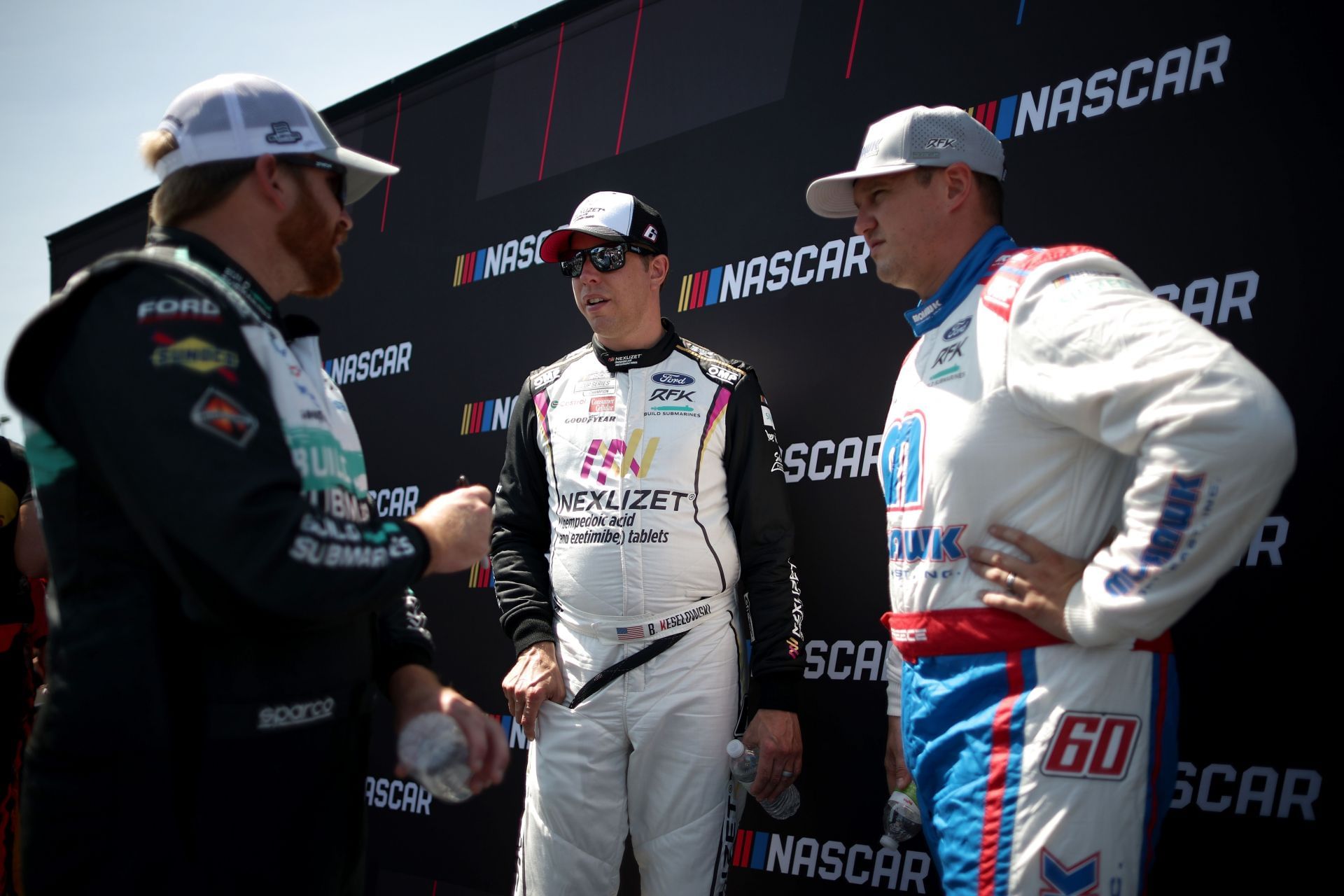 Brad Keselowski (C) speaks to Chris Buescher (L) and Ryan Preece at Watkins Glen. Source: Getty