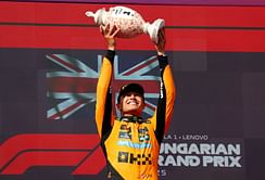 Lando Norris writes a cheeky quote on the champagne after winning the F1 Hungarian GP