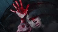A haunting image from Bring Her Back shows a bloodied hand pressed against glass, symbolizing desperation and fear. (Image via A24)