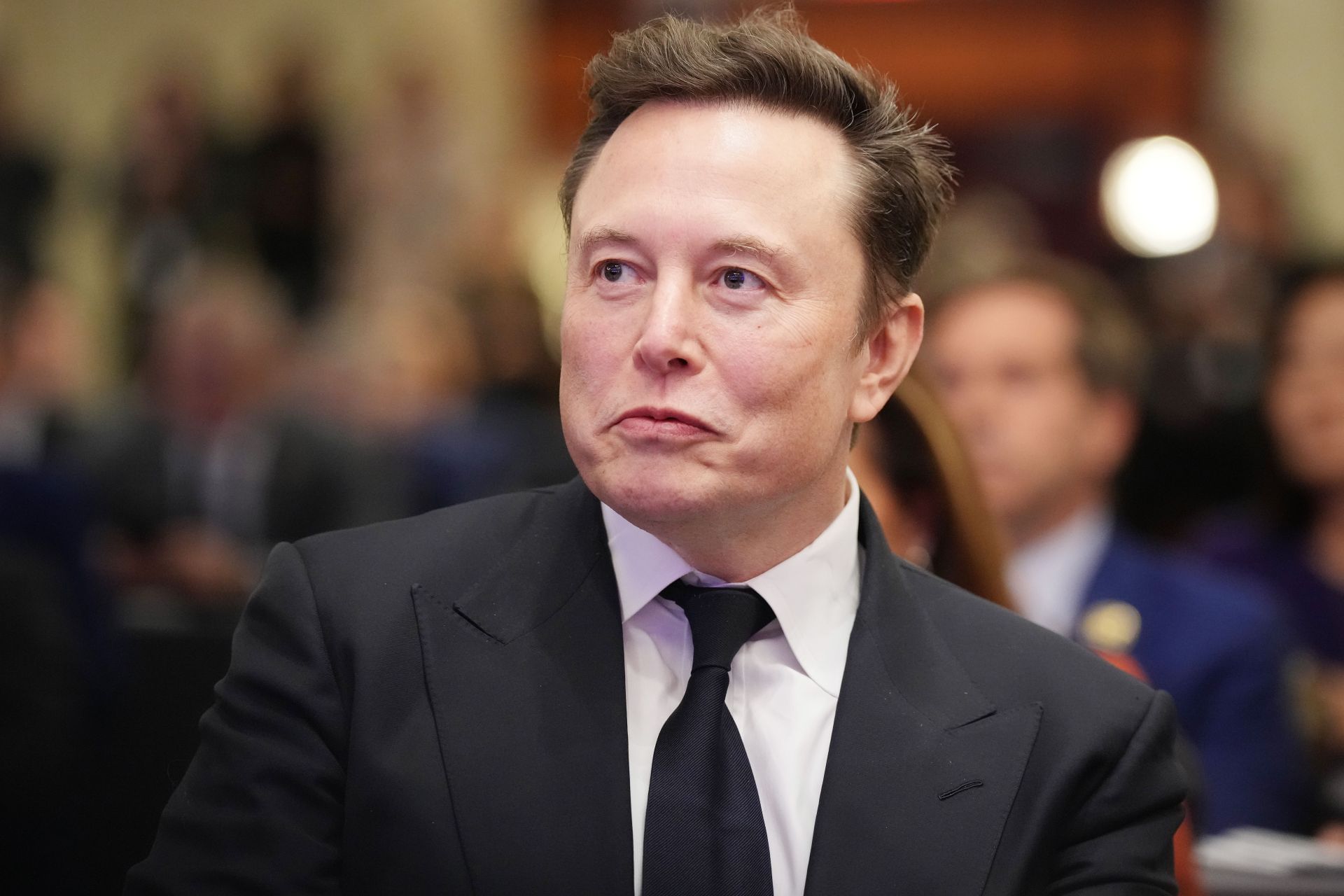 Elon Musk files lawsuit against Apple and OpenAI (Image via Andrew Harnik/Getty Images)