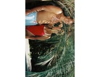 Rob Gronkowski's GF Camille Kostek poses in a red swimsuit with beau as the SI model shoots for her brand La Porte. [IG/@camillekostek