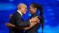 Barack Obama greets Michelle Obama as he arrives to speak on stage during the second day of the Democratic National Convention (Image via Getty)