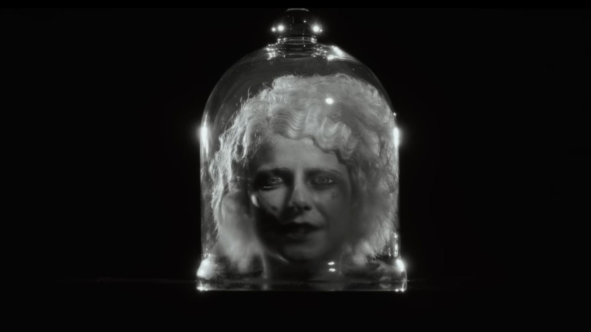 The teaser shows Jessie Buckley&rsquo;s bride encased in glass, a haunting moment from Maggie Gyllenhaal&rsquo;s The Bride (Image via YouTube/Warner Bros.)