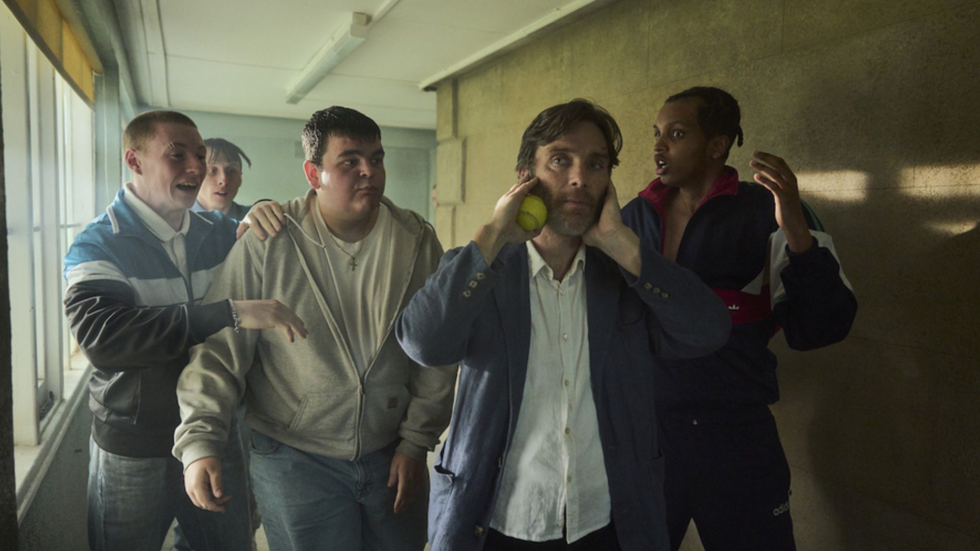  Cillian Murphy as Steve surrounded by a group of boys in a tense corridor sequence in the film Steve.