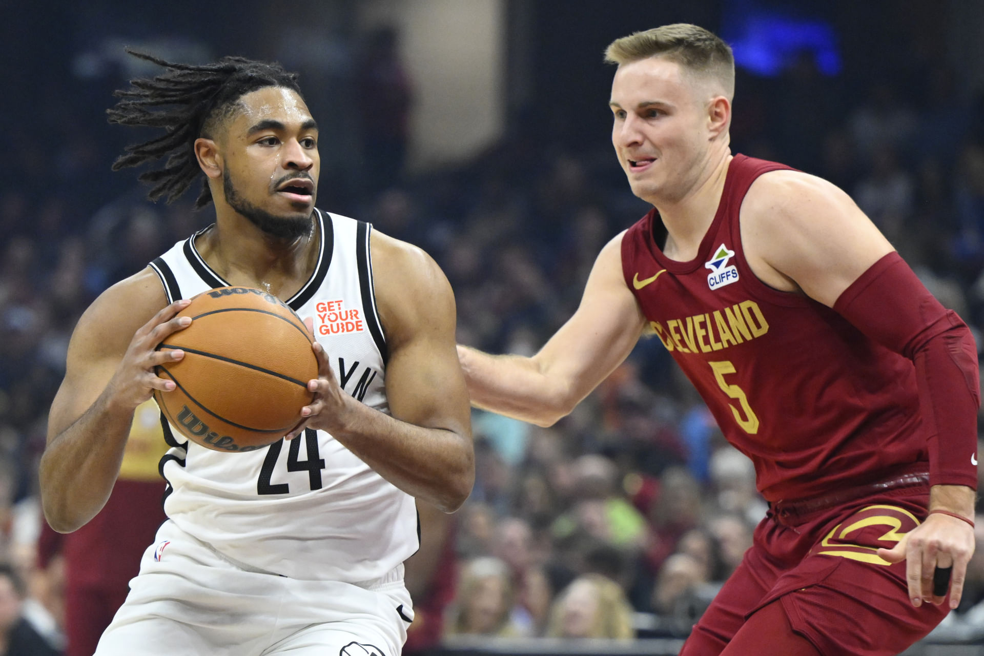 Cam Thomas dribbles beside Cleveland Cavaliers NBA guard Sam Merrill - Source: IMAGN