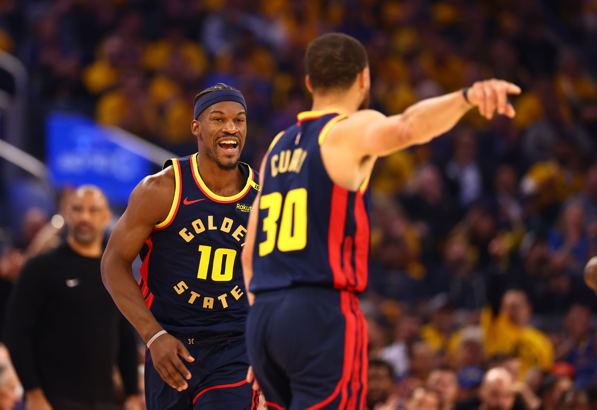 Golden State Forward Jimmy Butler III (10) celebrates towards guard Stephen Curry (30) after a basket against the Houston Rockets during the first quarter of game four of the 2025 NBA Playoffs first round at Chase Center. Mandatory Credit: Kelley L Cox-Imagn Images