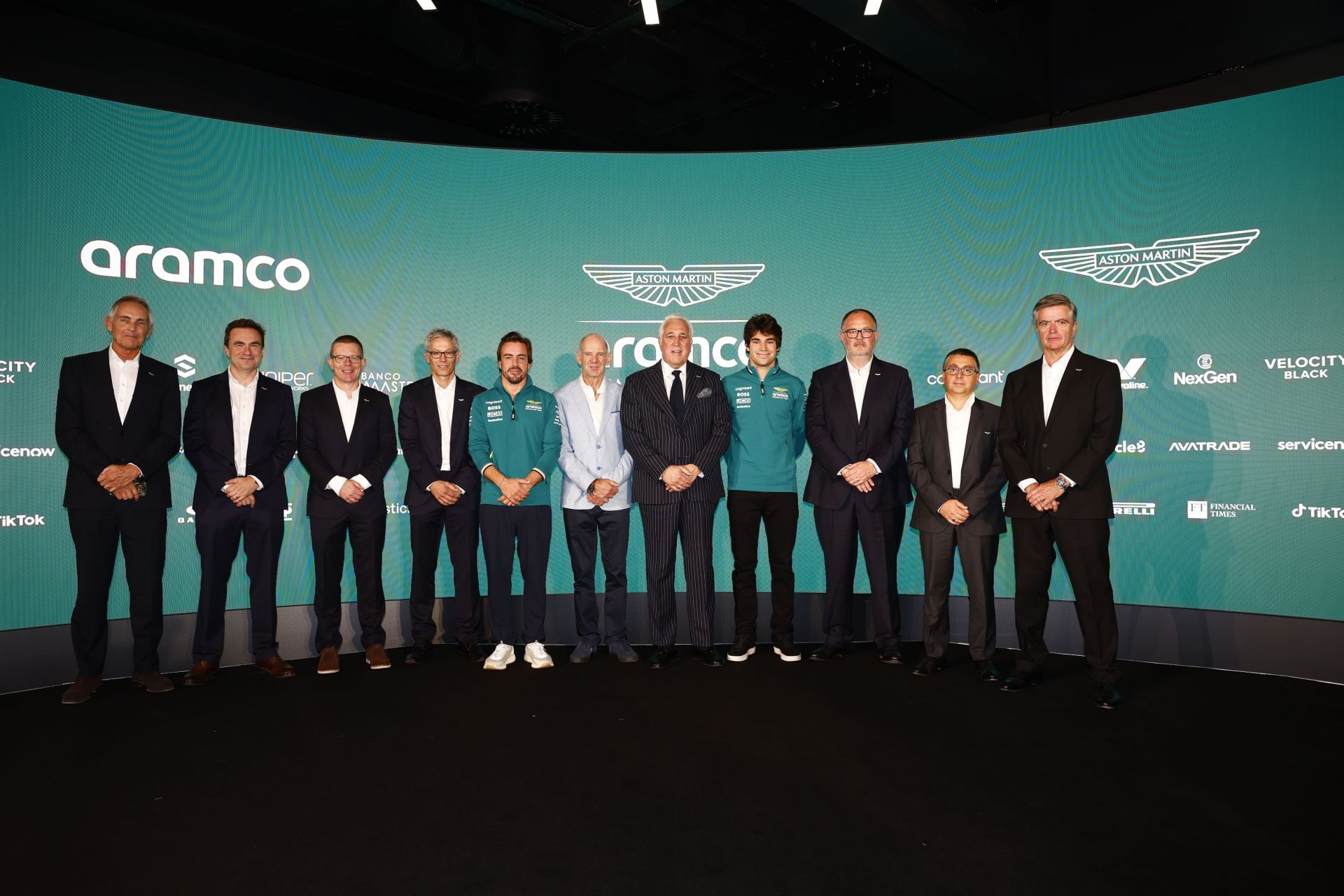 Fernando Alonso (C) with the Aston Martin F1 Team at the Silverstone Headquarters. Source: Getty