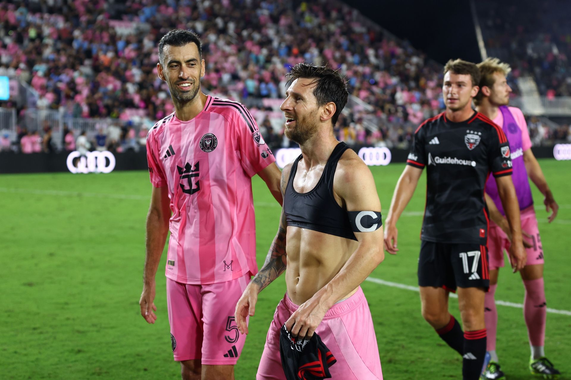 Lionel Messi (centre) and Sergio Busquets (left)