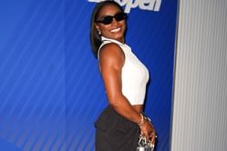 Simone Biles shows off luxury Audemars Piguet watches while posing in special white outfit during multi-billion dollar brand's event