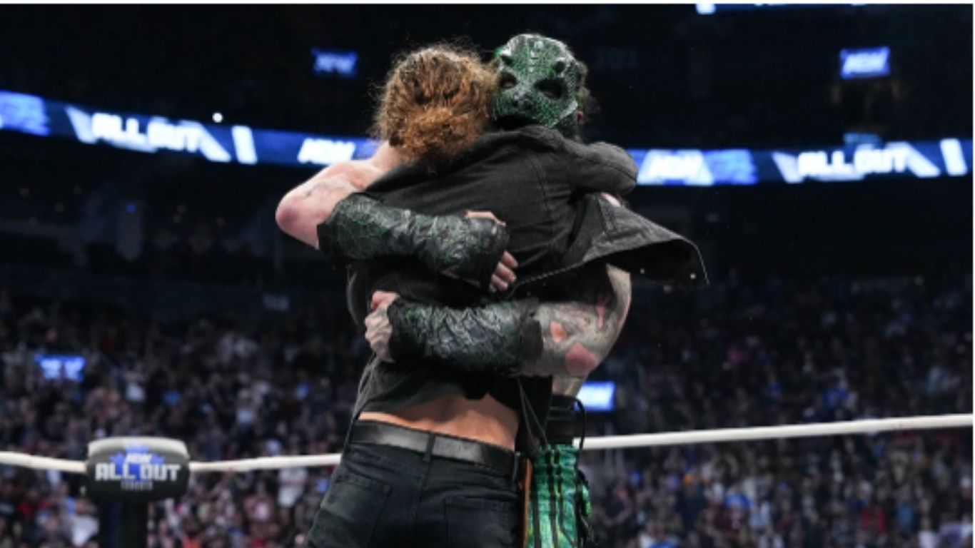 Jack Perry and Luchasaurus hug it out at All Out 2025 [Image via allelitewrestling.com]